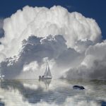 Sailboat on the horizon are dwarfed by huge storm clouds forming. #sailboat #amazing #clouds #sea #horizon #iPhone