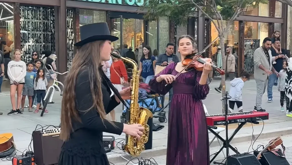 Careless Whisper, Street performance violinist, Teenage violinist talent, Saxophone and violin duet, George Michael cover song, Musical collaboration on streets, Heartwarming musical performance, Ukrainian violinist sensation, Saxophone tunes with violin, Viral street musicians, 80s classic reinvention