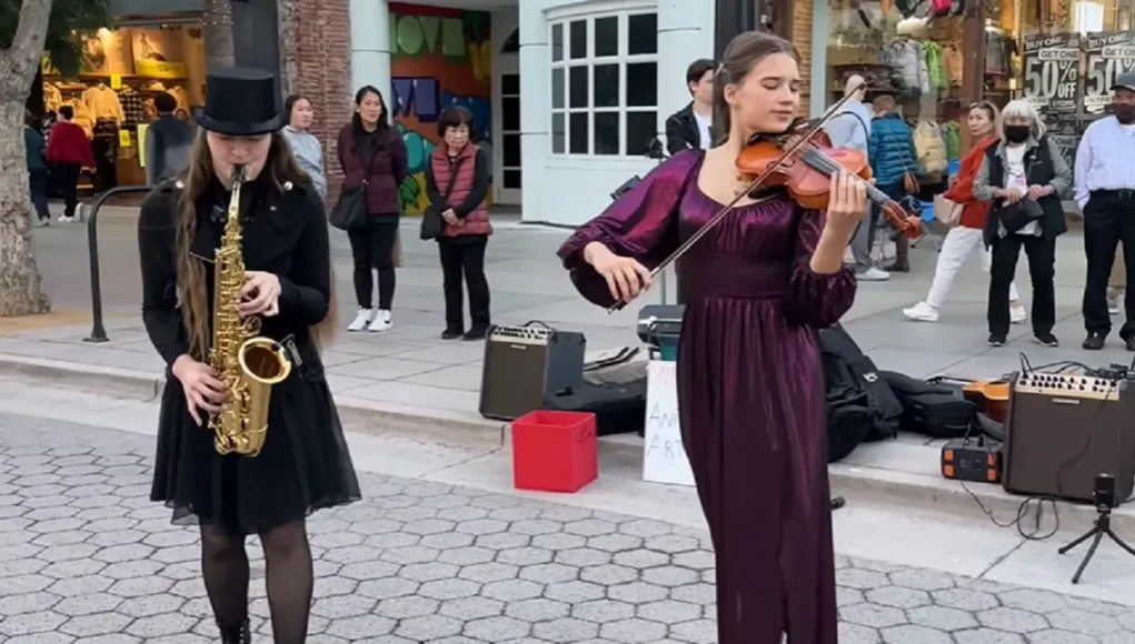 Careless Whisper, Street performance violinist, Teenage violinist talent, Saxophone and violin duet, George Michael cover song, Musical collaboration on streets, Heartwarming musical performance, Ukrainian violinist sensation, Saxophone tunes with violin, Viral street musicians, 80s classic reinvention