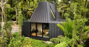 cabin living, modern cabin design, sustainable architecture, New Zealand cabin, minimalist retreat, tranquil living, compact space design, harmony with nature, purple heart Deccan, aluminum tray construction