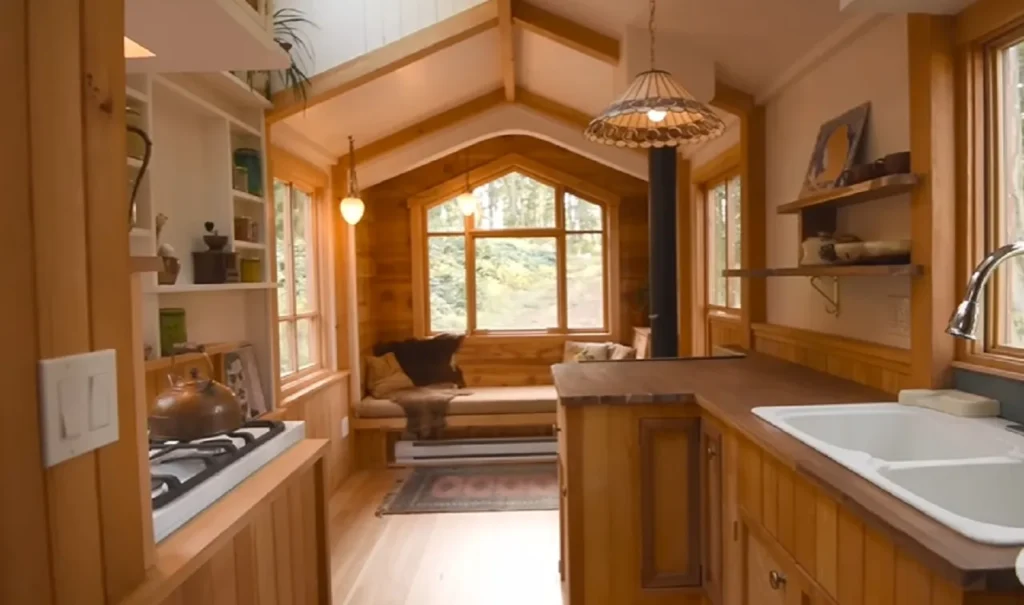 tiny house movement, handcrafted tiny house, modern aesthetics, downsizing benefits, sustainable living, tiny home craftsmanship, functional design, cozy tiny home, space-saving solutions, traditional warmth