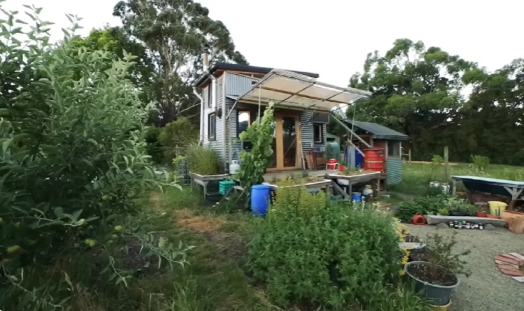 off-grid tiny house, sustainable tiny living, salvaged material home, eco-friendly tiny home, minimalist home design, mobile tiny house, permaculture tiny house, tiny house on wheels, alternative living solutions, sustainable off-grid lifestyle